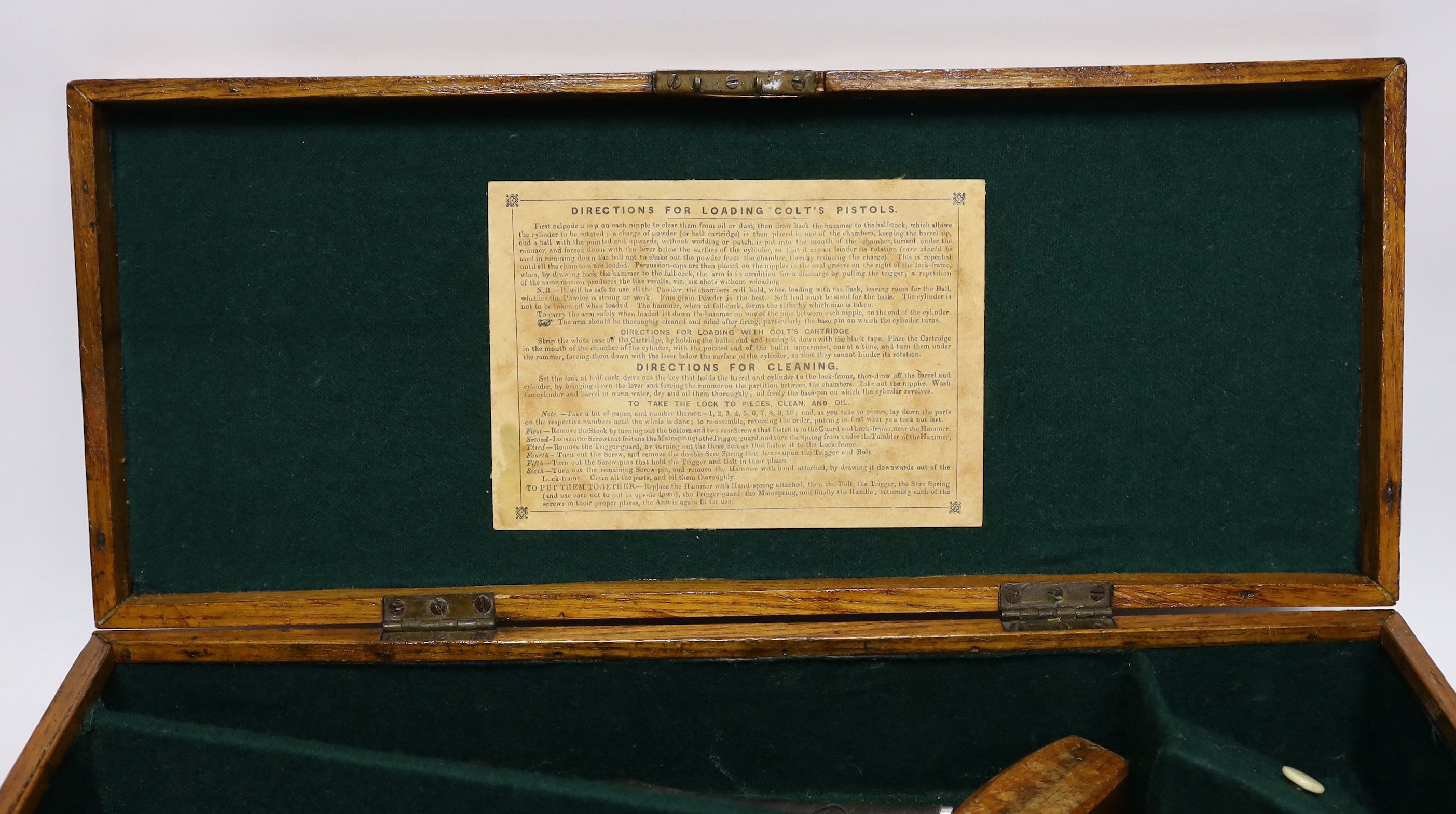 An oak Colt pistol box, felt lined compartments containing a few tools including a bullet mould, label for directions to the inside of the lid, dimensions 45.5 x 18 x 11.5cm